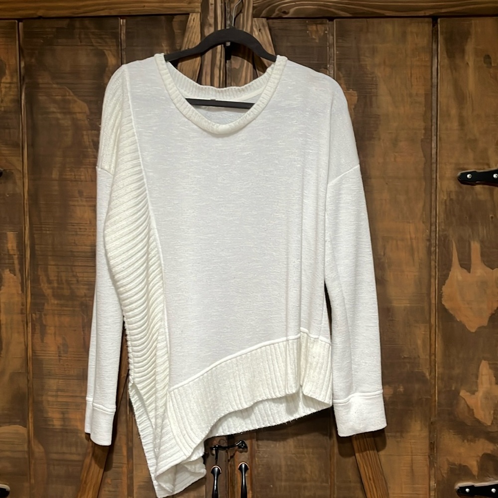 Beige sweater with longer side